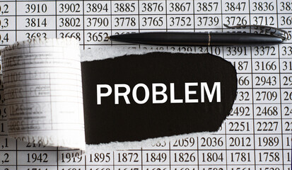 PROBLEM is the word behind torn office paper with numbers and a black pen.
