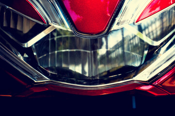 Abstract and darktone front of Motorcycle mask and headlights. With the sparkle of red.