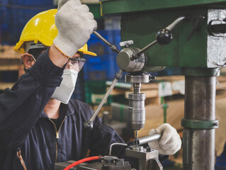 A worker working with lathes in the metal factory.