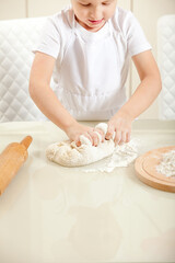 baby knead the dough in flour