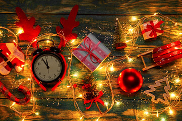 Christmas decorations and clocks showing five to twelve with burning garland
