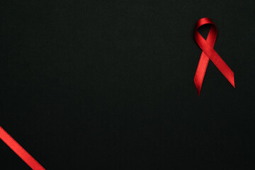 Infection symbol. Red ribbon symbol in hiv world day on dark background. Awareness aids and cancer. Healthcare and medical concept.
