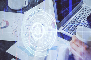 Obraz premium Multi exposure of technology hologram with man working on computer background. Concept of big data.