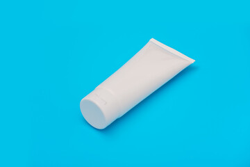Blank white tube design on a blue background. Mockup