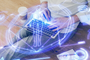 Science hologram with man working on computer on background. Concept of study. Double exposure.