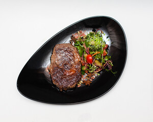 steak on a plate on a white background