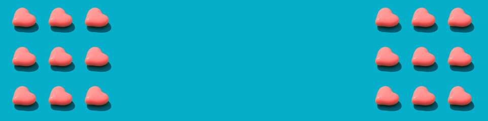 Composition background of pink heart candy on the blue background. Valentines Day concept banner