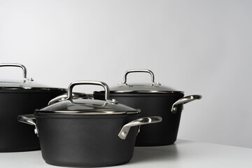 New domestic cookware on grey background close up