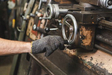 The worker producing the manufacturing metal parts