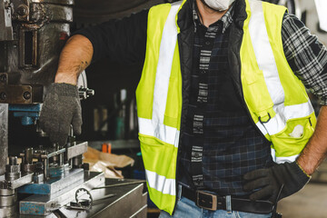 A factory engineer works in the factory metalwork.