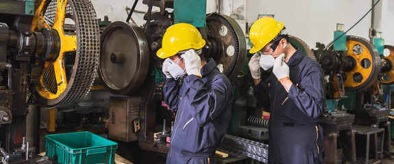 Industrial workers wear face masks in the factory.