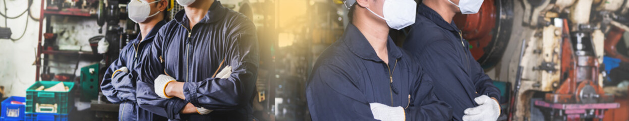 Workers in uniforms crossed arms in the factory.