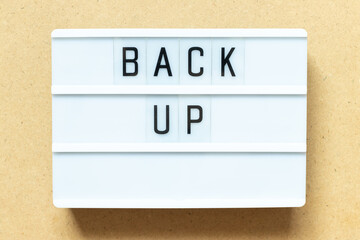 Lightbox with word back up on wood background