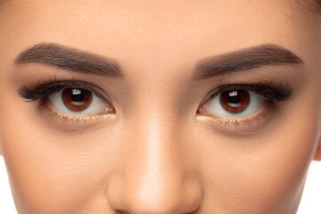 Obraz premium Eyes. Close up portrait of beautiful young woman on studio background. Concept of cosmetics, makeup, natural and eco treatment, skin care. Shiny and healthy look, fashion, healthcare. Details.