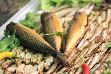 three dried mackerel in a market