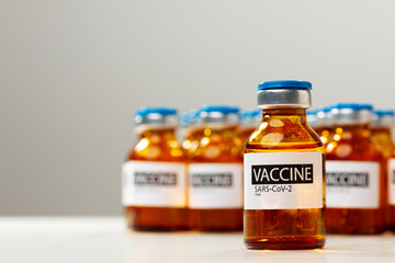 Sars-cov-2 vaccine vial bottles on white table