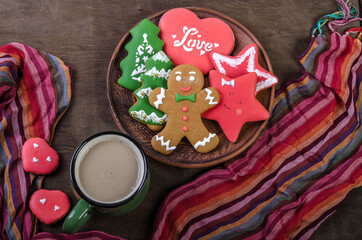 Christmas gingerbread cookies in a bowl and a mug of cocoa on a dark background.