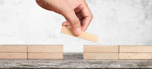 Hand arranging wood block . Business concept growth success