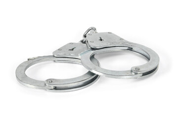 Handcuffs isolated on white background with light shadows. Pair of silver handcuffs macro close-up high resolution.