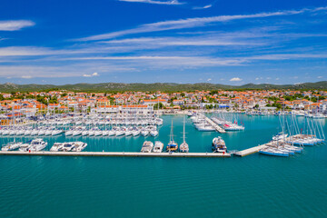 Fototapeta na wymiar Panoramic view of marina with sailboats on beautiful blue Adriatic seascape in town of Pirovac in Dalmatia, Croatia