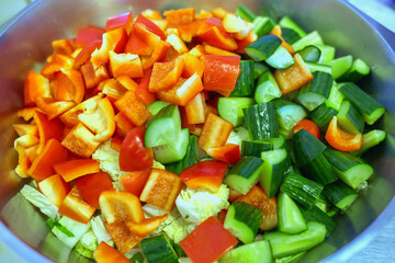 Coarsely chopped fresh vegetable salad in a large plate. Top view
