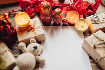 Christmas patter for postcard with craft paper, gift box, handmade christmas toys and candles. top view on wooden desk. Ornament And Christmas Gift. Santa Claus letter.