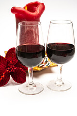 Popular british christmas drink, glass of vintage ruby port wine and candle with christmas tree decoration