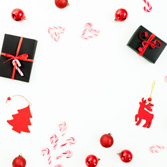 Christmas frame composition. Gifts, tree decoration and candy canes on white background. Flat lay