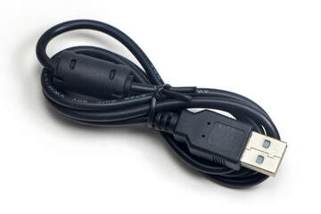Single black USB-cable. Isolated on white background. Close-up. Studio photography.
