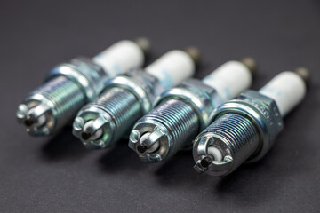 Spark plugs on black background. Car and motorcycle part