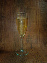 
glass of champagne on a wooden surface background