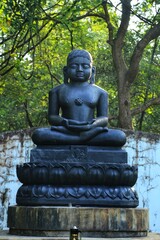 Fototapeta na wymiar Buddha statue in the garden. State Of Goa. India
