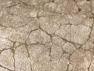 Old light brown concrete cracked stone cement wall for background