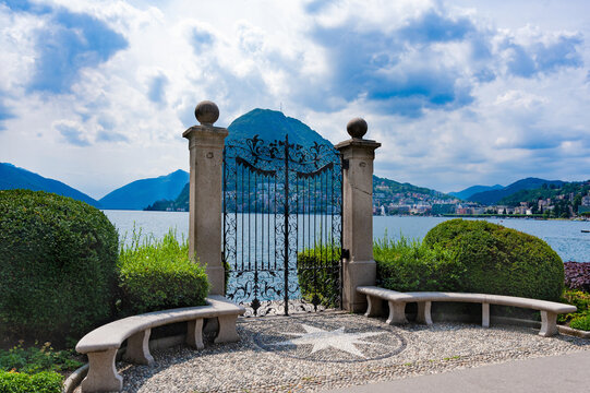 Europe.Switzerland.Ancient gate from the Chani park to Lugano.Blue sky with white clouds.