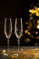 New year concept, two glasses of champagne, golden sparkle and highlights
