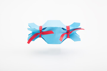 Blue original candy package with red ribbons on white