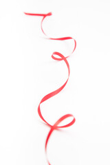 Vertical red wavy ribbon on white with copy space