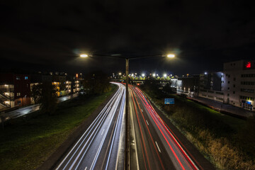Night timelapse or nightlapse of a motorway in stockholm during cloudy night. Car trails are seen on the road.