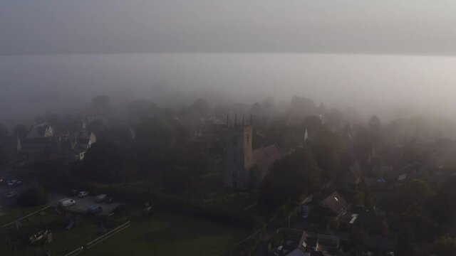 Drone Shot Orbiting Islip Church In Mist 01