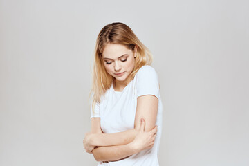 Fototapeta premium Cute blonde white t-shirt gesture with hands lifestyle light background