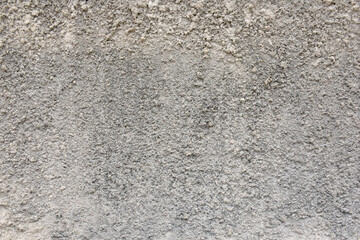 The background is made of rugged, gray-colored plaster walls.