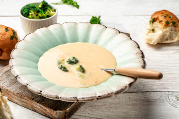 Vegetable and cheese cream soup with broccoli, homemade healthy organic vegetarian vegan diet fresh food meal dish soup lunch on a light background, top view