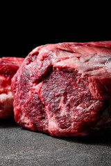 Vertical frame, cuts of raw aged premium marbled beef with plenty of fat for perfect steaks