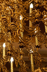 Vintage chandelier with candle light in a church