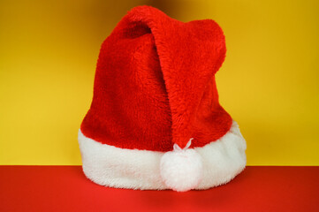 Obraz na płótnie Canvas Colorful christmas background with santa hat. Side view.