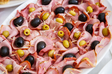 Nicely decorated banquet table with a variety of snacks and sandwich appetizers