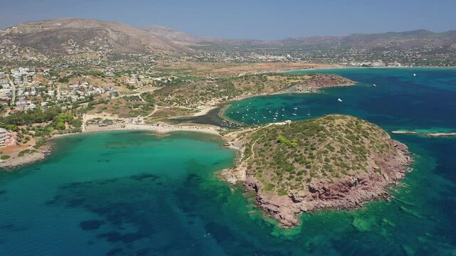 Aerial drone video of famous small islet with picturesque chapel of Agios Nikolaos and small marina, Anavissos area, Attica, Greece