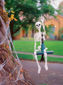 Silly friendly skeleton waving hello to trick or treators