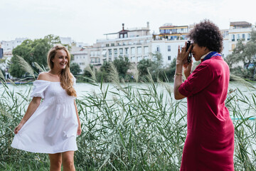 Friends taking photos next to the river