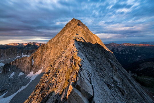 Idyllic shot of mountain peak against cloudy sky during sunset - Powered by Adobe